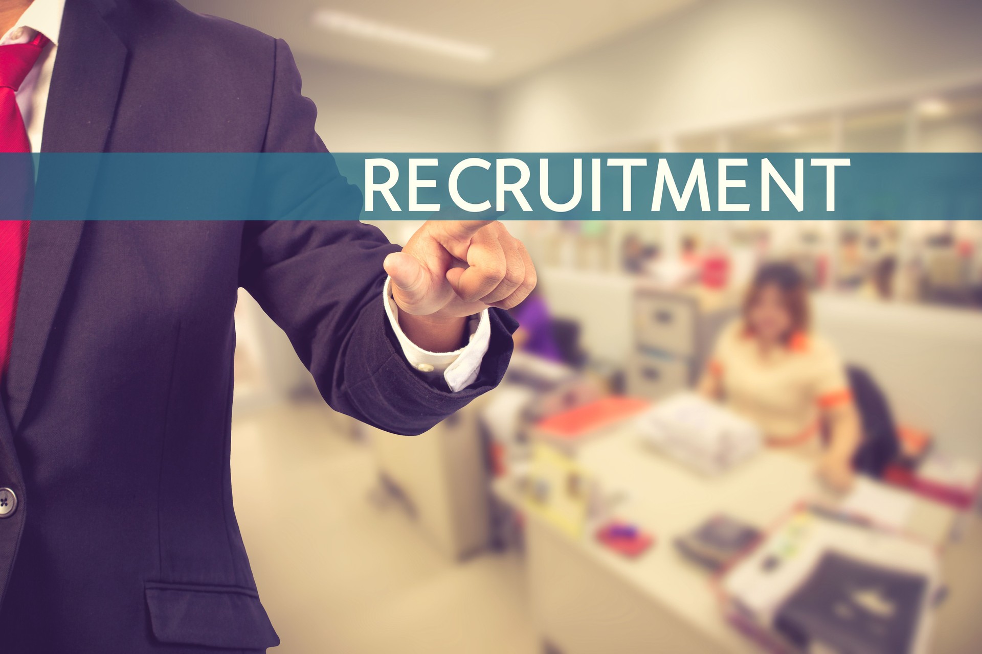 Businessman hand touching RECRUITMENT tab on virtual screen vint